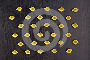 Pattern of A pile of conchiglie paste shells on black background