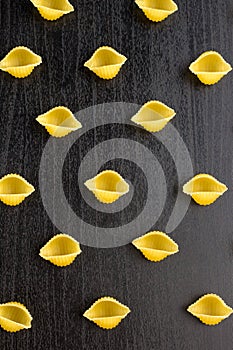 Pattern of A pile of conchiglie paste shells on black background