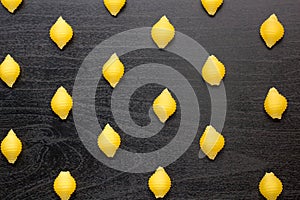 Pattern of A pile of conchiglie paste shells on black background