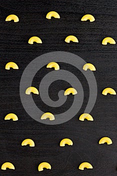 Pattern of A pile of pasta horns on black background