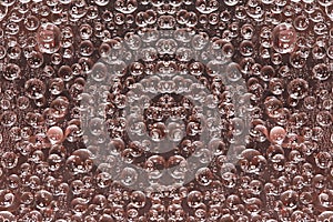 A pattern of pink-brown rings is symmetrically located on a brown background.