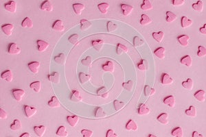 Pattern. Pink confectionery hearts on pink background, texture