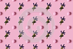Pattern of pink Easter eggs and spring flovers over pink background