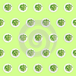 Pattern of plates with lightly fried brussels sprouts on the neon green drop
