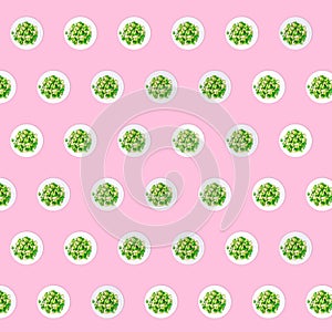 Pattern of plates with lightly fried brussels sprouts on the neon pink drop