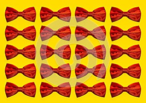 Pattern of red bow ties isolated on yellow background.