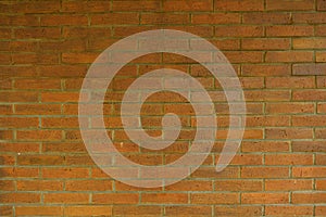 The pattern of red bricks on the wall