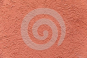 pattern of red painted plaster wall with rough structure