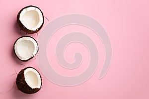 Pattern with ripe coconuts on pink background. Top View. Copy Space. Pop art design, creative summer concept. Half of