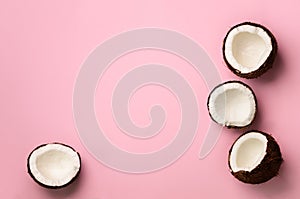 Pattern with ripe coconuts on pink background. Top View. Copy Space. Pop art design, creative summer concept. Half of