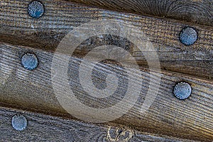 Pattern a row of old weather-beaten planks part of a board a boat bound by an iron riveted corrosion background