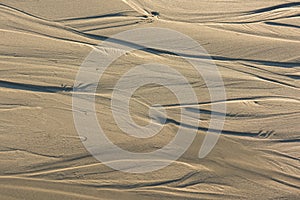 Pattern of sand after low tide at beach.