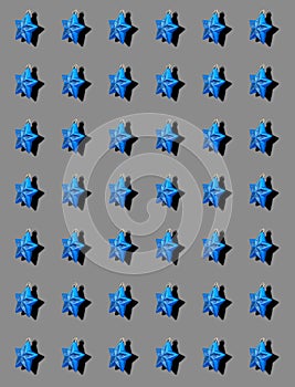 A pattern with shiny blue star-shaped decorations for New Year and Christmas