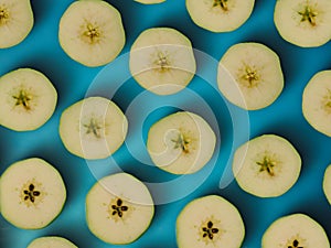 Pattern of sliced green apple. Wallpaper of fruits. Composition of sliced apples.Top view, flat lay
