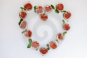 Pattern of sliced ripe figs with mint leaves in the form of a heart isolated on white background. Fruit illustration
