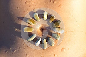 Pattern of small sea stones on women's skin, pebble beach