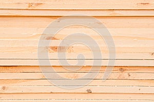 Pattern of stacked rectangular wooden beam timber at sawmill lumberyard