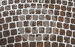 Pattern of stones and residual snow on the joints