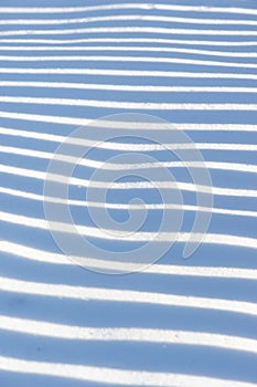 Pattern on surface of untouched snow photo