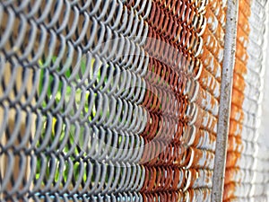 Pattern and texture of wire mesh fence covered with rust part