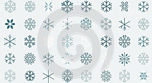 Pattern of various light blue and dark blue snowflakes arranged in a grid on a white