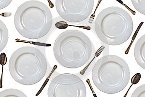 Pattern of vintage dinner plates, knives, forks and spoons