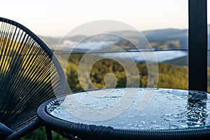 Pattern of water drops in a shiny metallic surface with table reflections