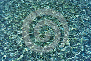 Pattern of wave on blue water swimming pool reflecting in the summer sun