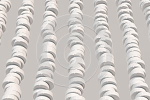 Pattern of white cylinder tablets on white background