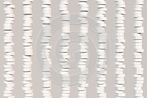 Pattern of white cylinder tablets on white background