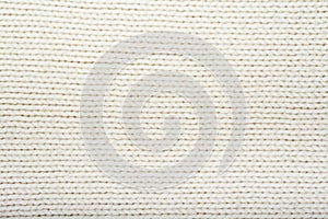 Pattern of the White Knitted Fabric Texture. Woolen background.