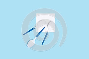 Pattern of white spoons on blue background.