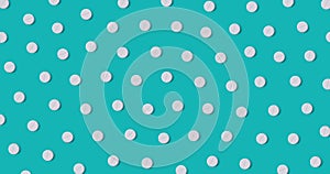 Pattern of white round pills on blue background