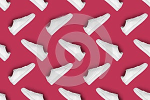 Pattern of white sneakers isolated on magenta (Viva Magen) background.