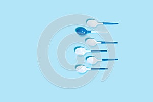 Pattern of white spoons on blue background.