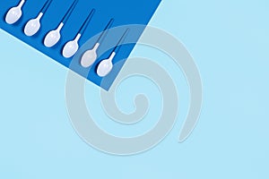 Pattern of white spoons on blue background.
