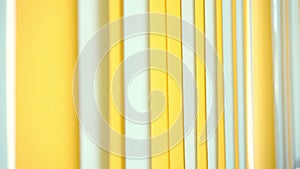 Pattern of white and yellow modern sunblinds hanging on big window