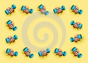 Pattern of woman hand holding blue dumbbell on yellow background. Fitness, sport, healthy lifestyle, diet concept. Banner with