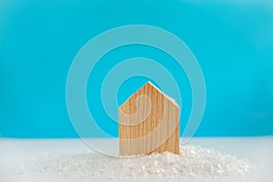 The pattern of the wooden house on a background. Christmas or New Year concept. House in the snow. Winter holidays card