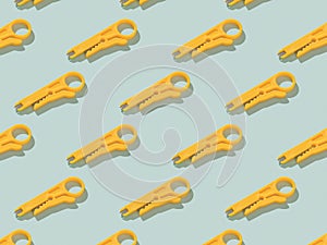 A pattern of yellow rj-45 cable cutting tools on a light background