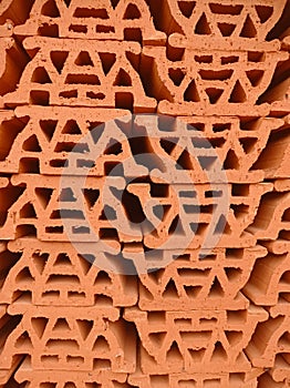 patterned abstract background, made of piles of stone building materials made of red clay