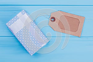 Patterned blue gift box and label tag.