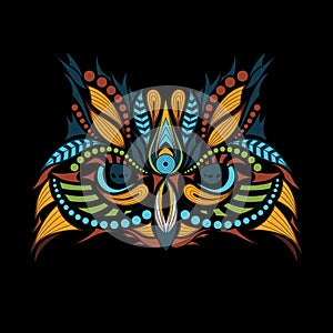 Patterned colored head of the owl on black. African / indian / totem / tattoo design