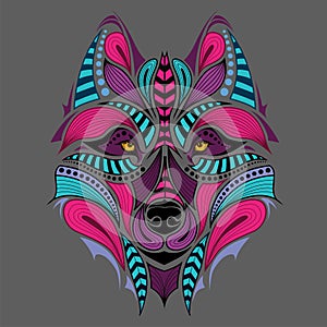 Patterned colored head of the wolf. African / indian / totem / tattoo design. It may be used for design of a t-shirt, bag