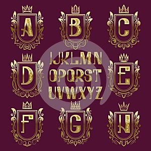 Patterned medieval coat of arms kit. Golden letters and ornamental wreath frames for creating initial logo