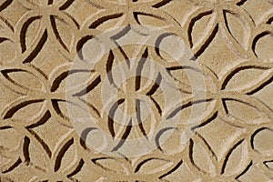 Patterned ornate made in sgraffito technique outside on the wall of warm beige colour in Segovia, Spain