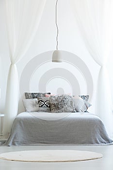 Patterned pillows on canopy bed