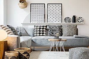 Patterned pillows on grey corner sofa in apartment