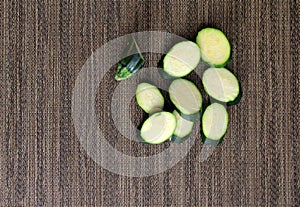 Patterned placemat with slices of fresh zucchini