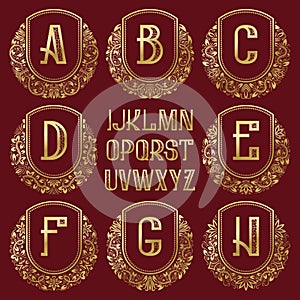 Patterned royal monogram kit. Golden letters and ornamental circular wreath frames for creating initial logo